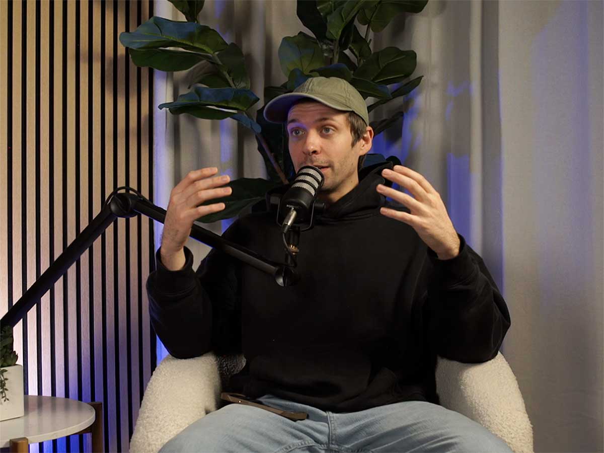 Dan doing a solo podcast with a white background set