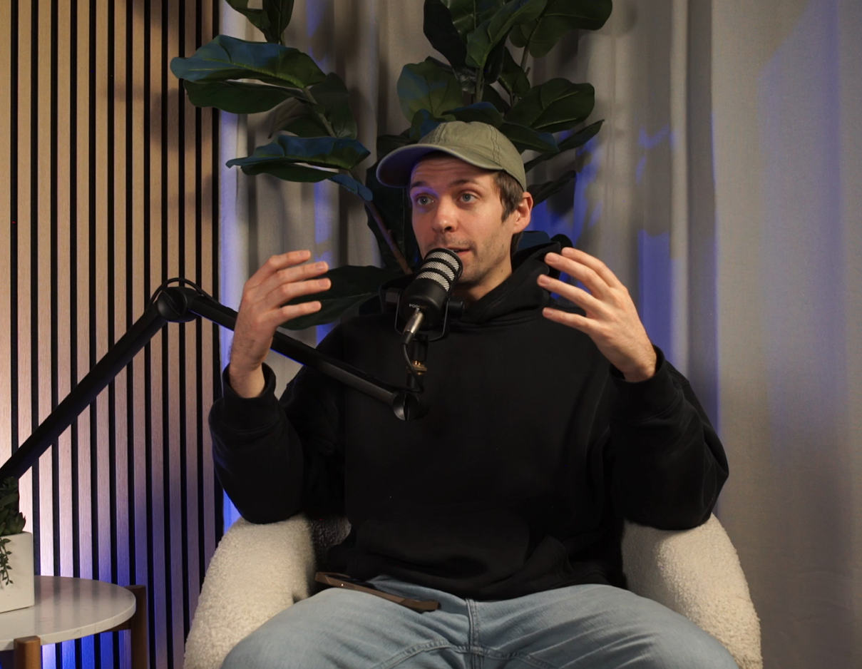 Dan doing a solo podcast with a white background set