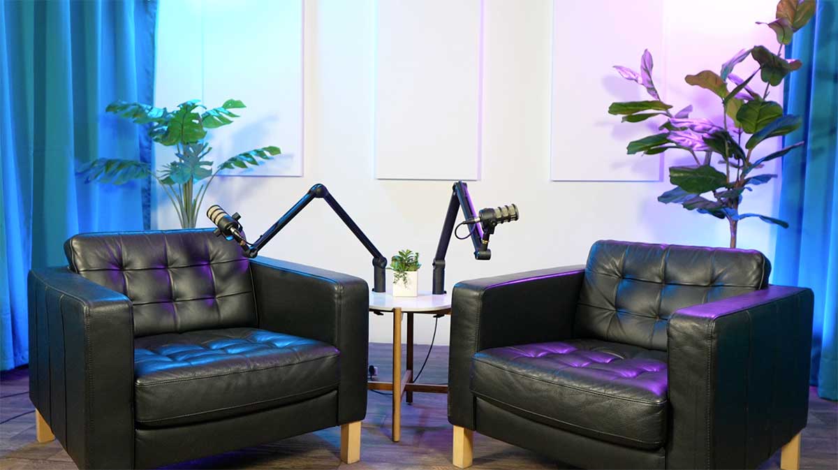 Our professional two person teal seat with black leather chairs with a white background.