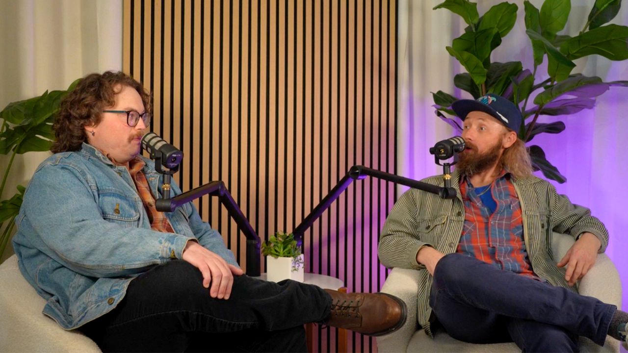 warmly lit Twin Cities podcast set with two people in swivel chairs.